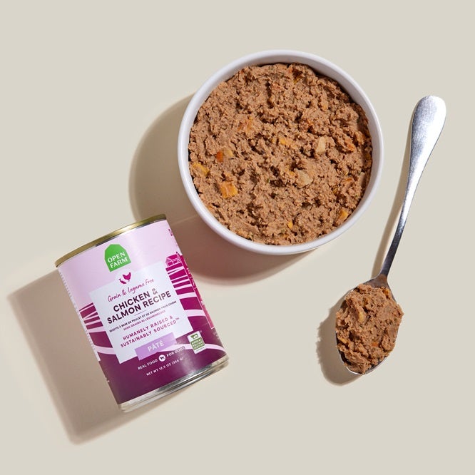 can of chicken and salmon pate with purple label product in a bowl next to a spoon