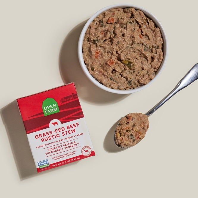 Grass-Feed rustic stew with red label next to bowl of stew and spoon