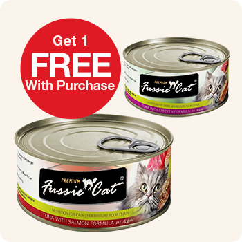 Two cans of Fussie Cat wet cat food, one with "Tuna with Salmon Formula" and the other "Tuna with Chicken Formula". A red circle overlay states "Get 1 FREE With Purchase".