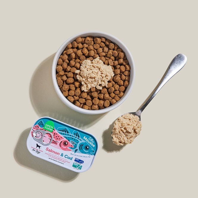 Tin of Icelandic fish topper with bowl of kibble and fish mousse on top with spoon