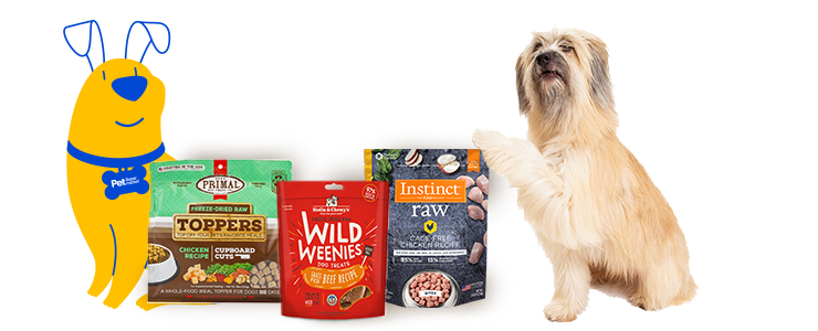 A fluffy tan dog is sitting on its hind legs with one paw raised, next to various bags of pet food products. The products include Primal Freeze-Dried Raw Toppers, Stella & Chewy's Wild Weenies, and Instinct Raw Boost Mixers. To the left of the pet food products is a yellow Pet Supermarket Peticon dog illustration, wearing a blue collar with a "Pet Supermarket" tag.